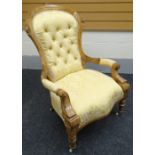 A carved walnut open armchair in yellow patterned buttoned upholstery; together with a carved oak
