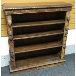 An English oak carved open bookcase of five shelves, 115cms, circa 1910s