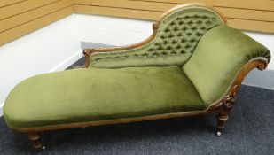 A chaise longue with carved and shaped back, buttoned green upholstery and with similarly