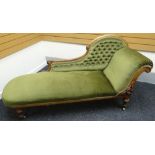 A chaise longue with carved and shaped back, buttoned green upholstery and with similarly