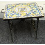 A small table, the top in the form of twelve Majolica tiles conjoining to depict a central religious