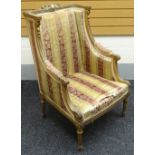 A French-empire style carved gilt-wood armchair, with ornate floral rail, striped upholstery,