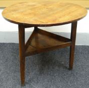 A joined-oak 'cricket' table, the three plank top raise over a centre tray, 77cms diam, circa 1850s
