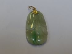 A carved jadeite pendant