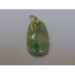 A carved jadeite pendant