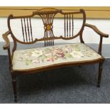 An inlaid mahogany Sheraton-style settee, with floral tapestry seat, circa 1910, 43ins wide (109cms)