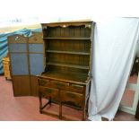 A good quality reproduction oak dresser having a three shelf rack with decorative frieze, the base