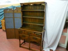 A good quality reproduction oak dresser having a three shelf rack with decorative frieze, the base