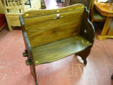 A neat 20th Century hall bench with peg jointed seat and sides and simple heart decoration, 95 cms