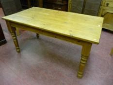 A Victorian style pine kitchen table on turned legs, 78 cms high, 153 cms long, 85 cms wide