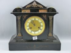 A black slate mantel clock in an architectural style case, the circular dial flanked by Corinthian