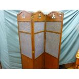 An oak three fold dressing screen with cloth covered central panels and simple fretted top