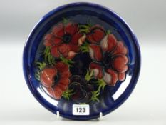 A Moorcroft pottery blue ground 'Anemone' plate, 22 cms diam