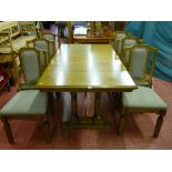 A modern Old Charm oak draw leaf dining table with additional leaf on twin turned column end