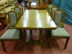 A modern Old Charm oak draw leaf dining table with additional leaf on twin turned column end