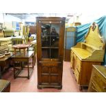A good quality reproduction oak one piece corner cupboard with six panel glass top and four