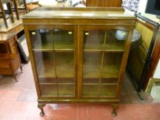 A 1930's walnut two door bookcase on cabriole supports, 116 x 90 cms