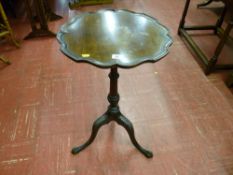 A late Victorian mahogany wine table with scalloped edge top, carved column and tripod base with