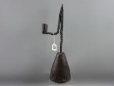 An 18th Century wrought iron rush nip light on a conical stained oak holder having simple punched