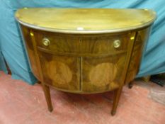 An early 20th Century bow front mahogany sideboard having single central drawer with brass ring