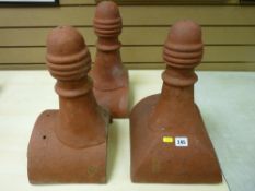 Three terracotta roof ridge finials, 42 cms high