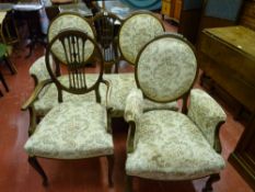 An early 20th Century drawing room suite of two seater couch and two elbow chairs, all with shield