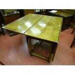 An antique drop leaf dining table with oblong stretchers and turned block supports, 114 cms wide,