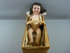 An Armand Marseilles full size doll with composition body and limbs (damage), 55 cms in length