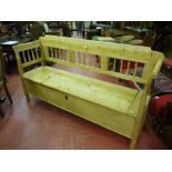 A European pine box seat settle with spindle gallery back and sides, lift-up seat with sectional