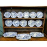 A parcel of Willow patterned pottery platters and circular plates as displayed on Lot 7