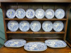 A parcel of Willow patterned pottery platters and circular plates as displayed on Lot 7