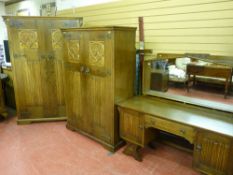 A good 20th Century oak four piece bedroom suite of lady's and gent's two door robes with