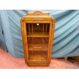 An early 20th Century oak bookcase/cabinet with single beaded glass door and carved decoration,