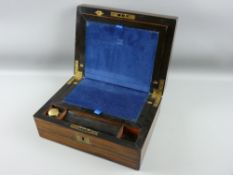 A Victorian rosewood writing slope with brass top plaque and escutcheon, velvet lined writing