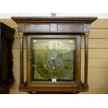 An 18th Century oak longcase clock having a square hood with turned pillars, brass dial with eight