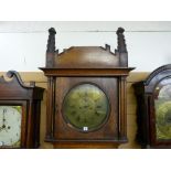 An early 19th Century Gothic style longcase clock, the 14 ins diameter circular brass dial with