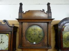 An early 19th Century Gothic style longcase clock, the 14 ins diameter circular brass dial with