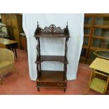 A reproduction mahogany whatnot with pierced gallery top shelf, two further shelves on turned and