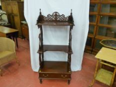 A reproduction mahogany whatnot with pierced gallery top shelf, two further shelves on turned and