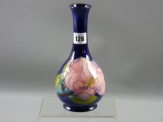 A Moorcroft pottery pink floral bottle vase, 21 cms high