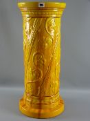 A Burmantofts yellow glazed jardiniere pedestal of cylindrical form with raised flowers to a wide