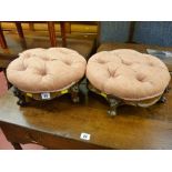 A pair of button upholstered carved walnut circular stools with carved decoration and knurled
