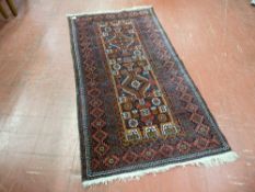 A vintage Eastern wide bordered woollen rug with tasselled ends, 164 x 87 cms, numbered cloth tag to