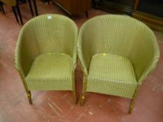 A gold painted Lloyd loom armchair with deep apron and one other similarly painted