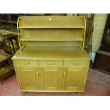 An Ercol style light wood sideboard with plate rack, approximately 120 cms wide
