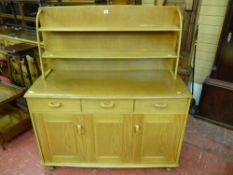 An Ercol style light wood sideboard with plate rack, approximately 120 cms wide