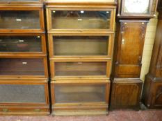 A four section oak Globe Wernicke stacking bookcase, 166 x 87 cms