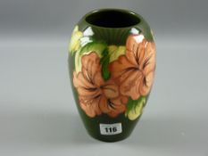 A Moorcroft pottery green ground 'Hibiscus' bulbous vase, 18 cms high