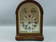 An early 20th Century mahogany dome topped mantel clock, the silvered dial set with Roman