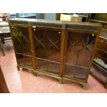 An early 20th Century mahogany breakfront bookcase, reeded frieze over three decorative beaded glass